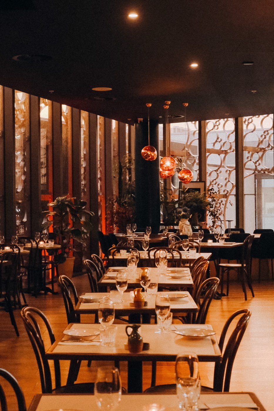 The level 2 dining room under copper lamps